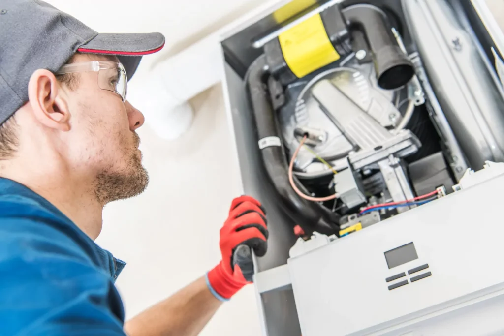 Hvac worker inspecting furnace