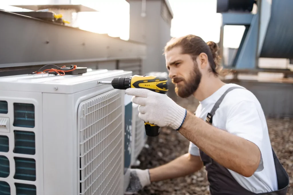 hvac technician working on outdoor unit