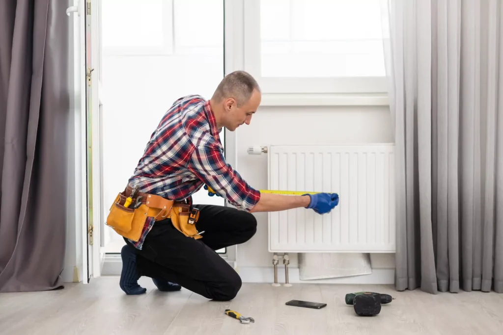 hvac worker repairing heating radiator